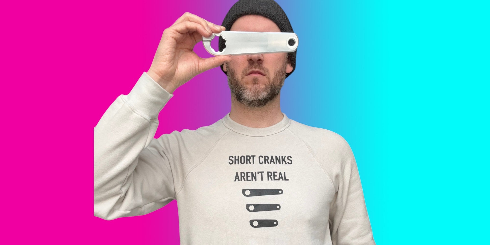 Matt Appleman holding a crank over his eyes wearing a shirt that says Short Cranks Aren't real